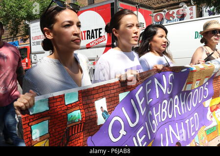 New York, NY USA. 30th. Jun, 2018. Alexandria Ocasio-Cortez, left, who democratic primary winner who defeated powerful US Congressman Joe Crowley (D-NY)  in the New York democratic primary on 26th. June, 2018 was a crowd favorite at the #FamiliesBelongTogether rally and march.The End Family Separation NYC Rally and March is one of several similar #FamiliesBelongTogether protest events taking place across the U.S. this weekend, 30th. June, 2018. This Queens, New York march and rally, took place in the most ethnically diverse neighborhood  of the city in Jackson Heights and drew hundreds of pass Stock Photo