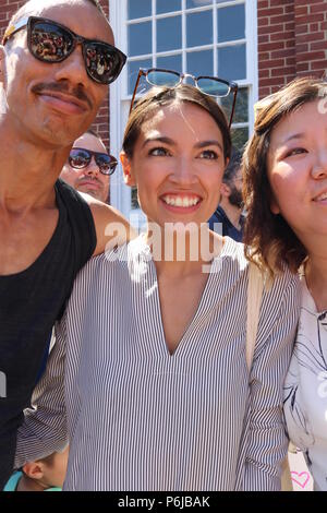 June 30, 2018 - New York City, New York, US - Alexandria Ocasio-Cortez, democratic primary winner who defeated powerful US Congressman Joe Crowley (D-NY) in the New York democratic primary on 26th. June, 2018 was a crowd favorite at the #FamiliesBelongTogether rally and march. The End Family Separation NYC Rally and March is one of several similar #FamiliesBelongTogether protest events taking place across the U.S. this weekend, 30th. June, 2018. This Queens, New York march and rally, took place in the most ethnically diverse neighborhood of the city in Jackson Heights and drew hundreds of pa Stock Photo