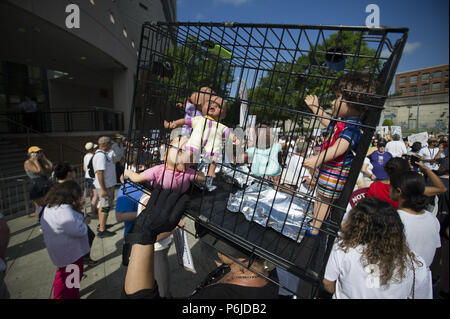 Atlanta, GA, USA. 30th June, 2018. Several thousand people gather outside Atlanta's city detention center to protest federal government's border policies Saturday, marching peacefully as part of a national effort to spotlight U.S. immigration policies that are separating children from their parents. The Families Belong Together event brought a large crowd together after a roughly half-mile procession that started at the Atlanta Detention Center and ended at the Richard B. Russell Federal Building Credit: Robin Rayne Nelson/ZUMA Wire/Alamy Live News Stock Photo