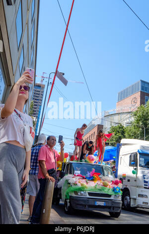 Milan, Italy. 30th Jun, 2018. Milano Pride 2018, manifestation of gay, lesbians, asexuals, bisexuals, intersexual and queer pride. Young woman and a man taking selfies during the parade. Milan, Italy. June 30, 2018. Credit: Gentian Polovina/Ģ����ý Live News Stock Photo