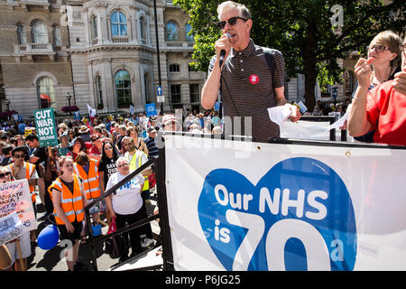 London, UK. 30th June 2018. Chris Nineham of Stop The War Coalition and Stop Trump addresses thousands of people, including many nurses, doctors and health workers, attending a rally and march to mark the 70th birthday of the National Health Service (NHS) and to demand an end to cuts to and privatisation of public services. The event was organised by the People's Assembly Against Austerity, Health Campaigns Together, the TUC and eleven other health trade unions. Credit: Mark Kerrison/Alamy Live News Stock Photo