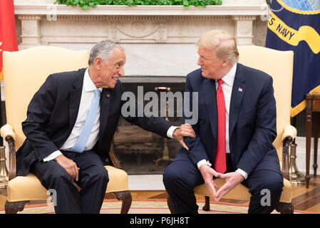 WASHINGTON, DC - WEEK OF JUNE 24: President Donald J. Trump listens to President Marcelo Rebelo de Sousa of the Portuguese Republic on Wednesday, June 27, 2018, during their meeting in the Oval Office of the White House  People:  President Donald Trump Stock Photo