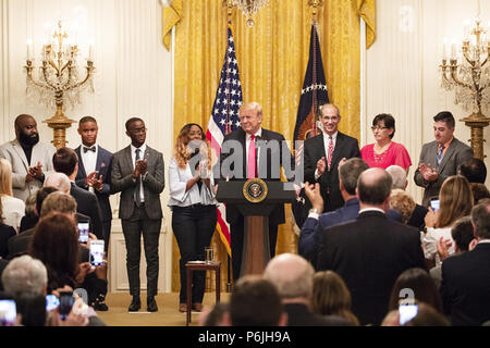 WASHINGTON, DC - WEEK OF JUNE 24: President Donald J. Trump is applauded as he addresses his remarks to celebrate the six-month anniversary and success of the Tax Cuts and Jobs Act on Friday, June 29, 2018, in the East Room of the White House  People:  President Donald Trump Stock Photo