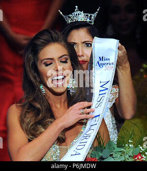 Lakeland, Florida, USA. 30th Jun, 2018. Sara Zeng, Miss Florida 2017, places a sash on Taylor Tyson, 23, after Tyson was crowned Miss Florida 2018 at the Miss Florida Pageant on June 30, 2018 at the RP Funding Center in Lakeland, Florida. She will represent Florida at the Miss America Pageant in September in Atlantic City. (Paul Hennessy/Alamy) Credit: Paul Hennessy/Alamy Live News Stock Photo