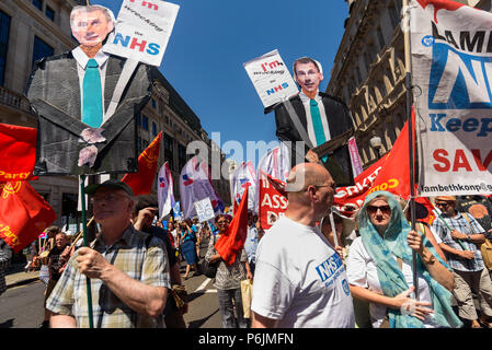 June 30, 2018 - London, UK. 30th June 2018. Peolpe carry placards showing Jeremy Hunt carrying a placard 'I'm Wrecking the NHS' on the march through London from the BBC to a rally near Downing St to celebrate 70 years of the NHS, and to support its dedicated workers in demanding a publicly owned NHS that is free for all with proper funding and proper staffing and providing a world class services for every community. The protest, organised by the the People's Assembly, Health Campaigns Together, Trades Union Congress, Unison, Unite, GMB, British Medical Association, Royal College of Nursing, Stock Photo