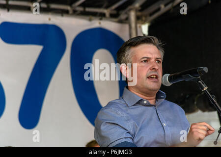 June 30, 2018 - London, UK. 30th June 2018. Shadow Health Minister Jonathan Ashworth MP speaks at the rally near Downing St to celebrate 70 years of the NHS, and to support its dedicated workers in demanding a publicly owned NHS that is free for all with proper funding and proper staffing and providing a world class services for every community. The protest, organised by the the People's Assembly, Health Campaigns Together, Trades Union Congress, Unison, Unite, GMB, British Medical Association, Royal College of Nursing, Royal College of Midwives, CSP, BDA, and SoR was to defend the NHS again Stock Photo