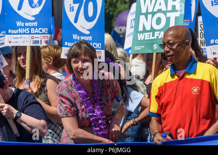 June 30, 2018 - London, UK. 30th June 2018. Frances O'Grady, TUC, General Secretary holds the main banner as the march through London from the BBC arrives at Downing St to celebrate 70 years of the NHS, and to support its dedicated workers in demanding a publicly owned NHS that is free for all with proper funding and proper staffing and providing a world class services for every community. The protest, organised by the the People's Assembly, Health Campaigns Together, Trades Union Congress, Unison, Unite, GMB, British Medical Association, Royal College of Nursing, Royal College of Midwives, Stock Photo