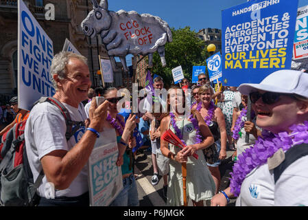 June 30, 2018 - London, UK. 30th June 2018. Campaigners from Huddersfield Royal Infirmary before thousands march through London from the BBC to a rally near Downing St to celebrate 70 years of the NHS, and to support its dedicated workers in demanding a publicly owned NHS that is free for all with proper funding and proper staffing and providing a world class services for every community. The protest, organised by the the People's Assembly, Health Campaigns Together, Trades Union Congress, Unison, Unite, GMB, British Medical Association, Royal College of Nursing, Royal College of Midwives, C Stock Photo