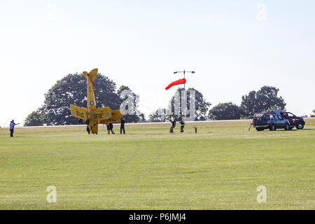 Sywell, Northamptonshire, UK. 30th June 2018. A Tiger Moth DH82 flipped on it's back on taxing this evening in the strong winds at The Blades Summer Ball at Sywell Aerodrome which is the home of the Blades Aerobatic dispay team. Credit: Keith J Smith./Alamy Live News Stock Photo