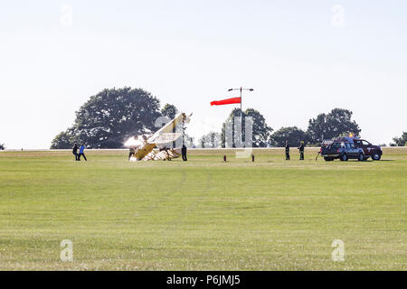 Sywell, Northamptonshire, UK. 30th June 2018. A Tiger Moth DH82 flipped on it's back on taxing this evening in the strong winds at The Blades Summer Ball at Sywell Aerodrome which is the home of the Blades Aerobatic dispay team. Credit: Keith J Smith./Alamy Live News Stock Photo