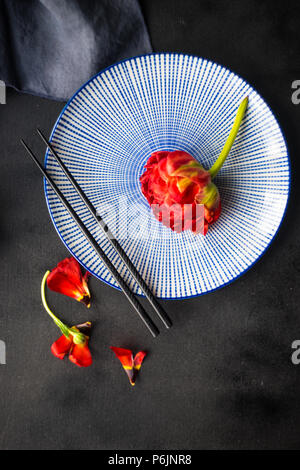 Summer table setting decorated with Red Princess tulips on rustic background Stock Photo