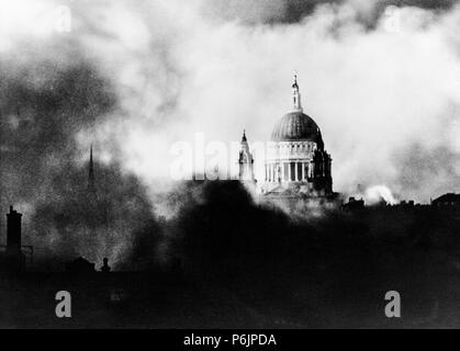 St. Paul's cathedral in London, surrounded by smoke and fires during the blitz by the German Luftwaffe in World War II in 1940.