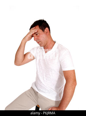 A close up image of a man in profile in a white shirt covering his face, suffering from pain, isolated for white background Stock Photo