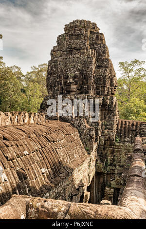 Bayon is richly decorated Khmer temple at Angkor in Cambodia. Built in 12th century as official state temple of Mahayana Buddhist King. It stands at t Stock Photo