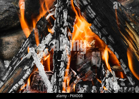 Burning bonfire with visible hot charcoal and ashes Stock Photo