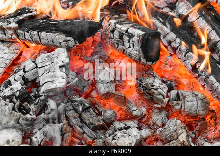 Burning bonfire with visible hot charcoal and ashes Stock Photo