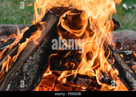 Burning bonfire with visible hot charcoal and ashes Stock Photo