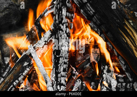 Burning bonfire with visible hot charcoal and ashes Stock Photo