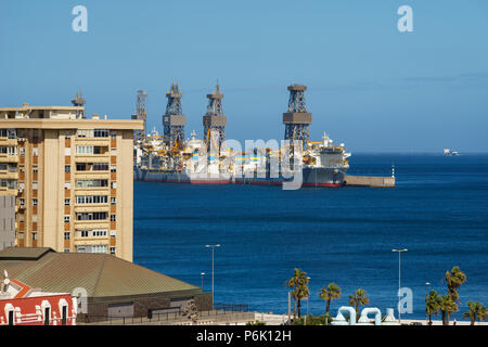 Drillships near coastal city. Oil and gas offshore drilling Stock Photo