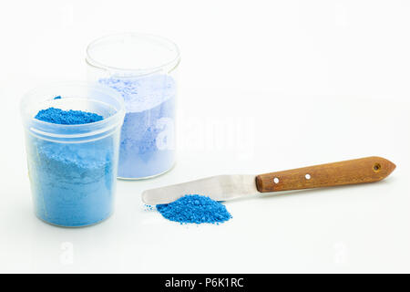 small buckets of color powder with a spatula - studio light Stock Photo