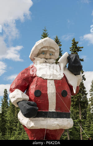 The worlds largest Santa Claus statue at the Santa Claus House in North Pole, Alaska. The 42-foot statue weighs 900 pounds and was originally built in the 1960s and originally served as a seasonal display at the Westlake Mall in Seattle before being relocated to North Pole. Stock Photo