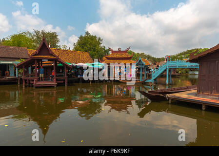 Laem Chabang, Thailand -- March 16, 2016. Tourists explore retail stores built over the water in Thailand. Stock Photo