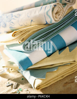 Close-up of pile of striped and plain blue and cream folded linen fabric Stock Photo