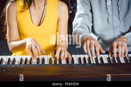 Piano teacher with his student in music school Stock Photo