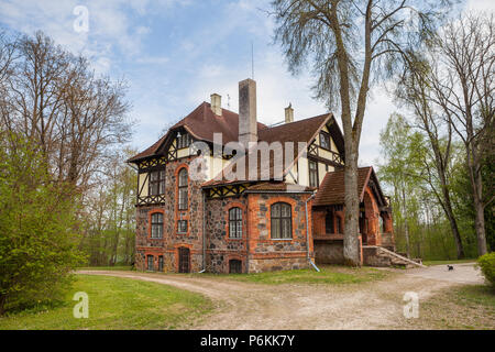 Stone house in Estonia, manor building decorated with granite. Summer time. Stock Photo