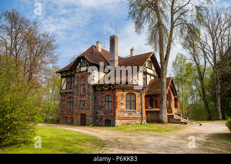 Stone house in Estonia, manor building decorated with granite. Summer time. Stock Photo