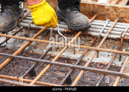 Tying reinforcing steel bars (rebar) for the construction. Tightening wire  using a pincers Stock Photo - Alamy