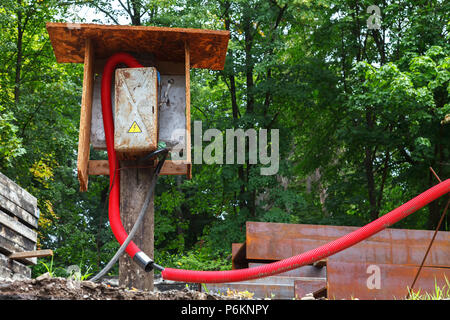 Temporary power electric board mounted on a board with a connected cable on the construction site Stock Photo