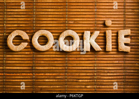 Cookie word composed of homemade biscuits letters arranged on wooden background Stock Photo