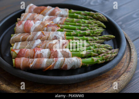 Asparagus wrapped in bacon on the hot pan Stock Photo