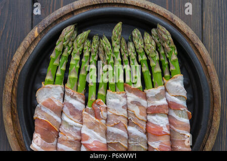 Asparagus wrapped in bacon on the hot pan Stock Photo