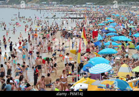 People on Bournemouth beach, Dorset as the hot weather continues across the country. Stock Photo