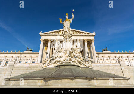 Austrian parliament building in Greek style with statues of philosophers and white columns with famous Pallas Athena fountain in Vienna. Stock Photo