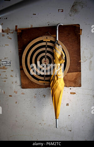 umbrella hanging on dart board Stock Photo