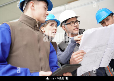 Instructor with young people in engineering training Stock Photo