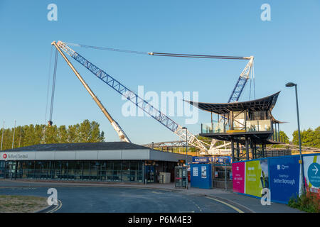 Telford Central Station, Telford, Shropshire, UK, Sunday July 1st 2018.  One of Europe's largest mobile cranes lifts a new section of railway footbridge into place over the railway line next to the A442 Queensway Road, Telford.  The 95 ton Liebherr LG1750 mobile crane lifed the first crossing section onto it's mounts in the early hours of Sunday morning 1st July 2018.  The civil engineering project is replacing the original footbridge at a cost of around £10 million. Credit: AMD Images/Alamy Live News Stock Photo