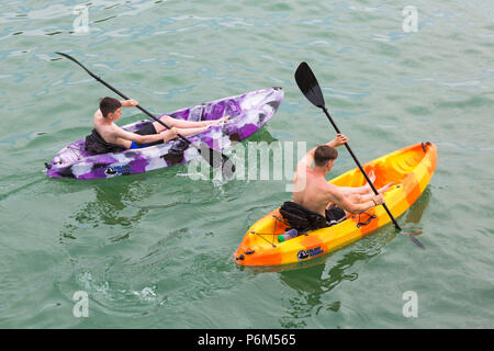 Bournemouth, Dorset, UK. 1st July 2018. UK weather: hazy sunshine, but still warm as thousands of sunseekers head to the beaches at Bournemouth to enjoy a day at the seaside. Two kayakers in the sea. Credit: Carolyn Jenkins/Alamy Live News Stock Photo