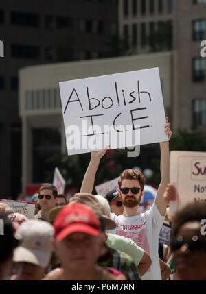 Boston, Massachusetts, USA. 30th June, 2018.  U.S. Student holding a sign 'Abolish I.C.E.' as thousands gathered in City Hall Plaza in Boston, MA, to protest the current United States administration policy of immigrant family Separation. Rallies against U.S. President Donald Trump’s policy of the detention of immigrants and immigrant families separated by U.S. customs and border agents (I.C.E.) took place in more than 750 US cities on June 30th. Chuck Nacke / Alamy Live News Stock Photo