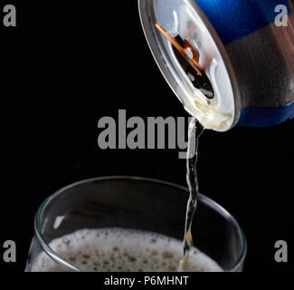 Close-up of pouring beer from metal can in glass Stock Photo