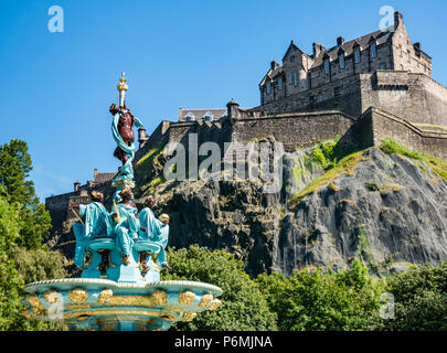 Victorian cast iron Ross fountain, restored and brightly painted in blue and gold with Edinburgh Castle, Princes Street Gardens, Edinburgh, Scotland, UK Stock Photo