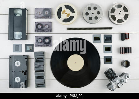 Creative Flat Lay of old vintage information medium of 90s on white wooden background. Top view. Stock Photo