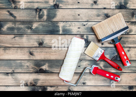 Top view of professional house painter work tools on an antique wooden table Stock Photo