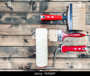 Top view of professional house painter work tools on an antique wooden table Stock Photo