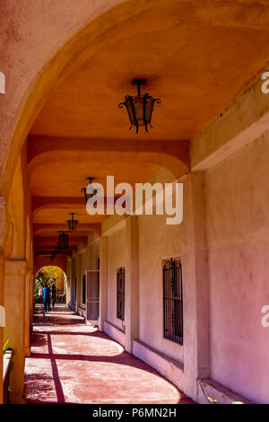 The colorful arched hallway casts beautiful shadow along the side walk located in Old Town Albuquerque New Mexico USA Stock Photo