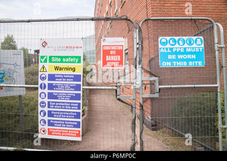 Health and safety signage and security fencing on a construction site, England, UK Stock Photo
