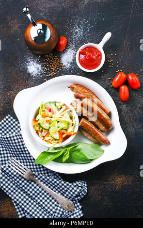 grilled sausages with salad on white plate, stock photo Stock Photo